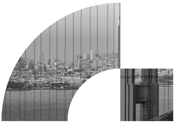 The San Francisco skyline seen through the cables of the Golden Gate Bridge, in black and white